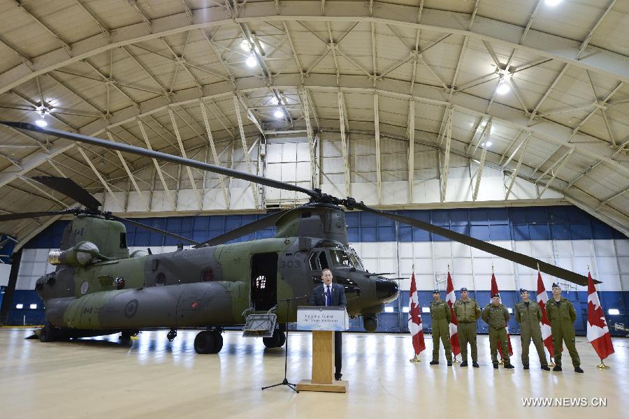 Canadian Defense Minister Peter MacKay addresses the unveiling ceremony of new CH-147F Chinook helicopters in Ottawa June 27, 2013. The 15 newly purchased F-model Chinooks will be engaged in support, domestic and foreign operations for the Royal Canadian Air Force's reactivated "450 Tactical Helicopter Squadron" based in Petawawa, Ontario. (Xinhua/James Park)