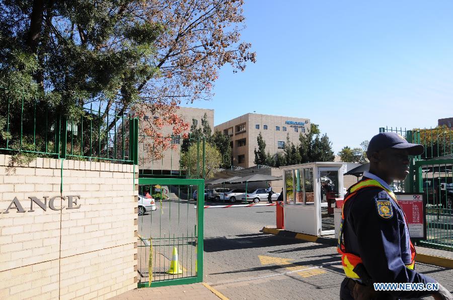 A policeman stands guard outside the hospital where South Africa's anti-apartheid icon Nelson Mandela gets medical treatment in Pretoria, South Africa, on June 28, 2013. Mandela's condition continues to improve, Mandela's ex-wife Winnie Madikizela-Mandela said on Friday. (Xinhua/Guo Xinghua) 