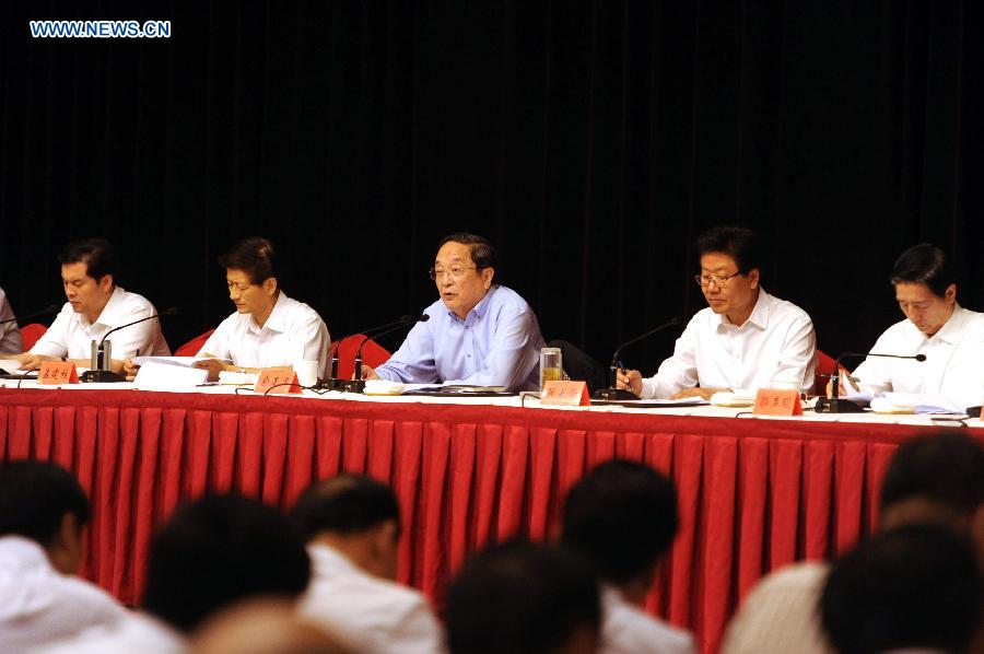 Yu Zhengsheng (C), member of the Standing Committee of the Political Bureau of the Communist Party of China (CPC) Central Committee, addresses a meeting attended by local officials in Urumqi, capital of northwest China's Xinjiang Uygur Autonomous Region, June 29, 2013. (Xinhua/Sadat)