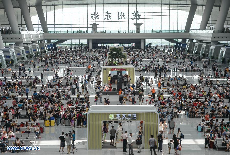 Passengers are seen at the newly-opened Hangzhou East Station in Hangzhou, capital of east China's Zhejiang Province, July 1, 2013. With the building area of 1.13 million square meters, the Hangzhou East Station, China's largest railway terminal, officially opened on Monday. (Xinhua/Zhu Yinwei)