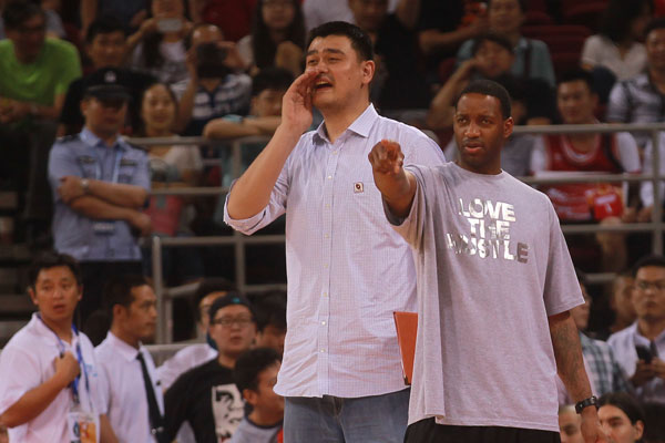 NBA star Tracy McGrady, right, stands beside his former Houston Rockets' teammate Yao Ming at a charity basketball game between the NBA All-star team and Chinese National team organized by the Yao Foundation in Beijing, July 1, 2013. All proceeds from ticket revenue for the charity game themed "All For Children" will go to the Yao Foundation Hope Primary School Basketball Season, which aims to provide a better future for children in poor areas by improving public welfare and sports programs. NBA All-star team won 61-58. (chinadaily.com.cn/Cui Meng)