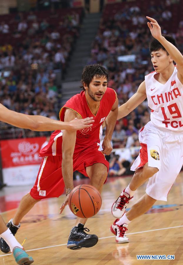 NBA star Ricky Rubio (L) drives the ball during a Yao Foundation Charity Game, sponsored by the charity foundation initiated by former Chinese basketball star Yao Ming, between the Chinese team and a team of NBA stars in Beijing, China, July 1, 2013. (Xinhua/Meng Yongmin)
