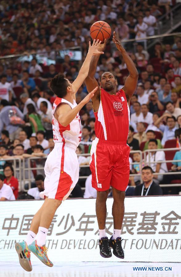 NBA star Metta World Peace (R) shoots the ball during a Yao Foundation Charity Game, sponsored by the charity foundation initiated by former Chinese basketball star Yao Ming, between the Chinese team and a team of NBA stars in Beijing, China, July 1, 2013. (Xinhua/Meng Yongmin)