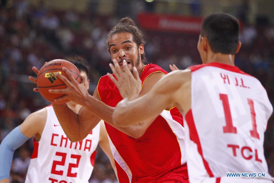 NBA star Joakim Noah (C) drives the ball during a Yao Foundation Charity Game, sponsored by the charity foundation initiated by former Chinese basketball star Yao Ming, between the Chinese team and a team of NBA stars in Beijing, China, July 1, 2013. Team of NBA stars won 61-58. (Xinhua/Ding Xu)
