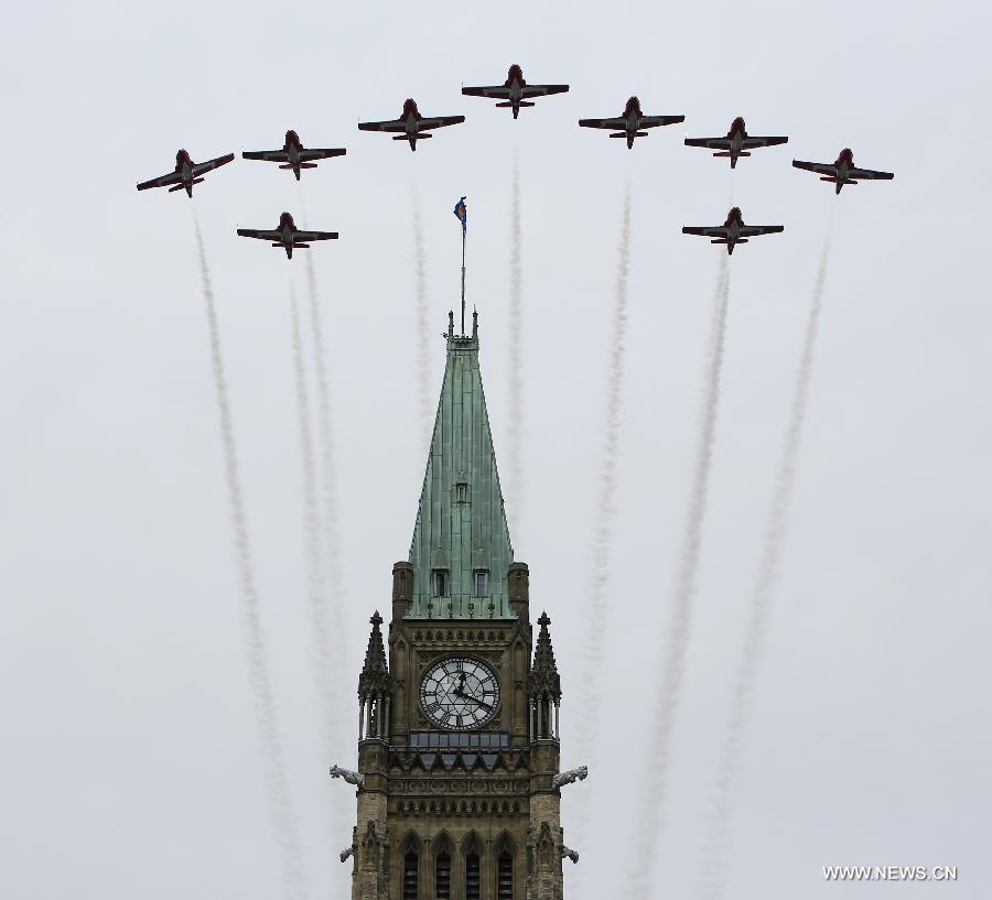 Aircraft of "The Snowbirds" fly over the Peace Tower of Parliament Hill as a part of Canada Day celebrations in Ottawa, capital of Canada, on July 1, 2013. Celebrations were held across the country to mark the 146th anniversary of Canada's foundation. (Xinhua/David Kawai) 