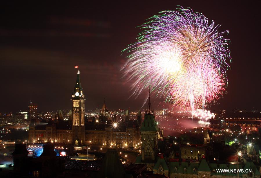 Fireworks are set off at Parliament Hill as a part of Canada Day celebrations in Ottawa, capital of Canada, on July 1, 2013. Celebrations were held across the country to mark the 146th anniversary of Canada's foundation. (Xinhua/Jodi Ellen Chamberlin) 