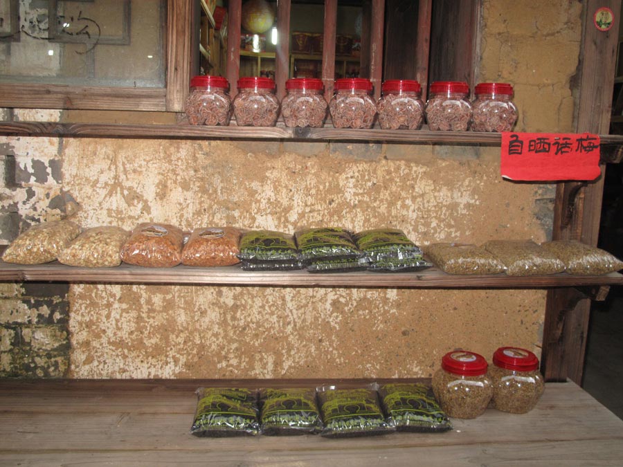 Plum candy and other snacks made by locals for sale. (CnDG by Jiao Meng)