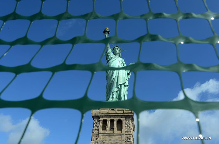 The Statue of Liberty is seen on the Liberty Island in New York, the United States, on July 4, 2013, the U.S. Independence Day. The Statue of Liberty and Liberty Island reopened to the public on Thursday for the first time since Hurricane Sandy made landfall on Oct. 29, 2012. (Xinhua/Wang Lei) 