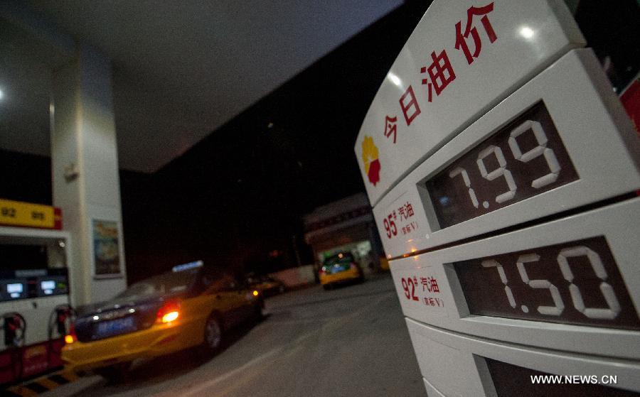 Photo taken on July 6, 2013 shows a board displaying fuel prices at a gas station in Beijing, China, July 6, 2013. China cut the retail price of gasoline by 80 yuan (12.9 U.S. dollars) per tonne from Saturday and that of diesel by 75 yuan per tonne, the country's top economic planner said on Friday. (Xinhua/Zhang Yu)