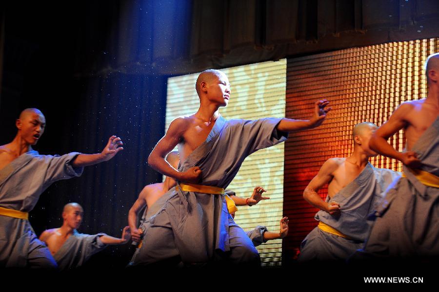 Performers of the Yandong Shaolin Kungfu troupe show their Kungfu during a performance held at the Worker's Cultural Palace, Taiyuan, capital of north China's Shanxi Province, July 6, 2013. The martial art troupe have their performers trained in the renowned Shaolin Temple, and staged performances worldwide in the hope of promoting Shaolin-style martial arts and Chinese culture. (Xinhua/Fan Minda)
