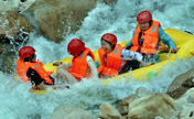 Tourists enjoy river rafting in China's Henan