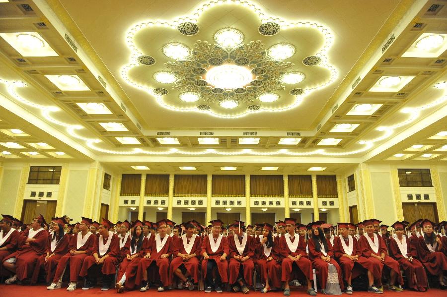 Graduates attend the graduation ceremony held by Beijing Concord College of Sino-Canada for its senior high graduates in Beijing, capital of China, July 6, 2013. A total of 303 senior high students graduate from Beijing Concord College of Sino-Canada this year, among which ten were admitted by universities in China, other 293 were accepted by universities from abroad, according to the school authority. (Xinhua/Lu Peng)
