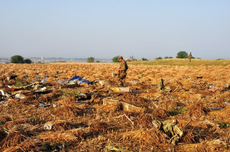 A Pakistani soldier searches the plane crash site on the outskirts of Islamabad, capital of Pakistan, on April 21, 2012. All passengers and the crew aboard a Pakistani plane that crashed near Islamabad have been declared dead after the rescue teams found the wreckage, the country's Interior Minister Rehman Malik said.(Xinhua/Ahmad Kamal)