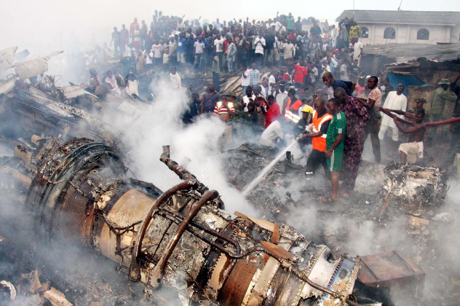 The wreckage of the crashed plane is seen near the Lagos airport in Nigeria, June 3, 2012. A passenger plane carrying 153 people crashed into a two-storey building in Nigeria's southwestern Lagos State on Sunday, killing all the people on board and 40 others on the ground. At least four Chinese were among the passengers, the Chinese Embassy in the West African country has confirmed. (Xinhua File Photo)