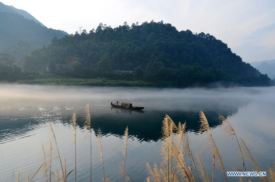 A fisherman fishes on the Xiaodongjiang River in Zixing City, central China's Hunan Province, July 7, 2013. (Xinhua/He Maofeng)