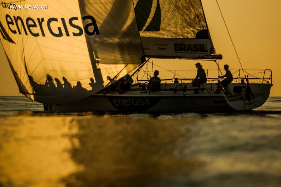 The crew of the "Magia V" yacht of the Brazilian Olympic medalist and world champion of the Round the World race, Torben Grael, competes in the Rolex Ilhabela Sailing Week 2013, held in the Ilhabela Yacht Club, in Ilhabela, Brazil, on July 7, 2013. The Ilhabela Sailing Week is the greatest oceanic boat race in Latin America, with more than 150 inscribed boats and teams from more than 8 countries. Brazilian Olympic medalist and world champion of the Round the World race, Torben Grael, leads the competition until now. (Xinhua/Marcos Mendez)