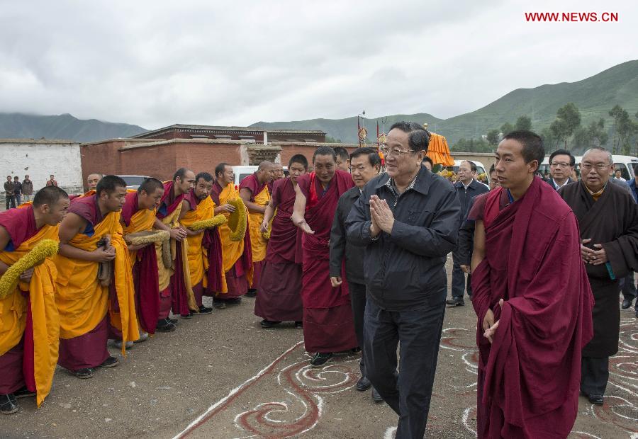 Yu Zhengsheng (2nd R, front), a member of the Standing Committee of the Political Bureau of the Communist Party of China (CPC) Central Committee and chairman of the National Committee of the Chinese People's Political Consultative Conference, visits religious figures at the Labrang Monastery in Gannan Tibetan Autonomous Prefecture, northwest China's Gansu Province, July 8, 2013. Yu made an inspection tour in Gannan recently. (Xinhua/Li Xueren)