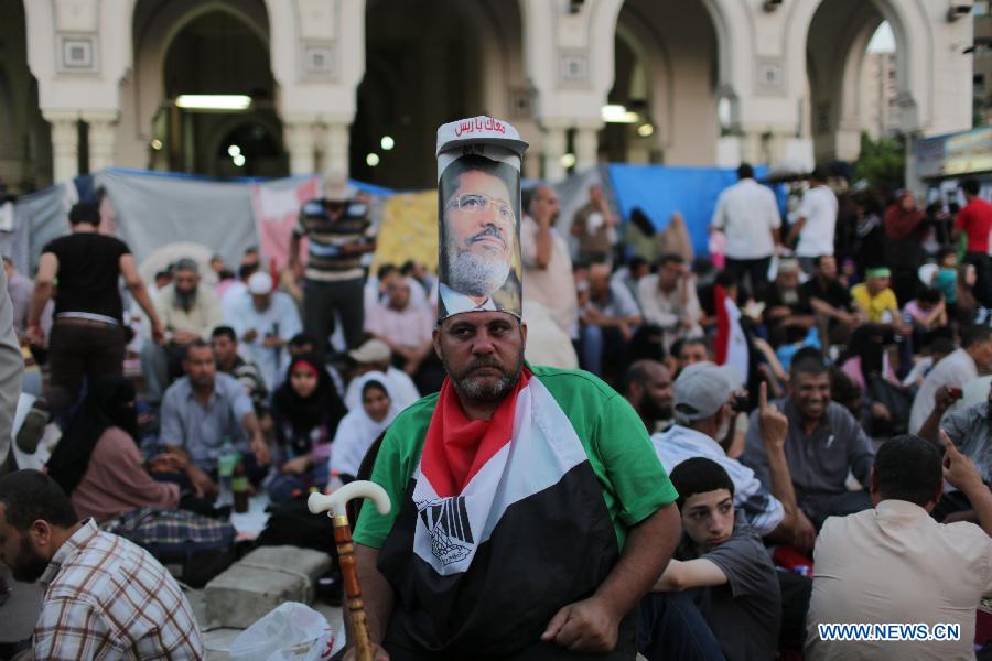 A supporter of ousted Egyptian President Mohamed Morsi attends a protest near the Rabaa al-Adawiya mosque, in Cairo, Egypt, July 12, 2013. (Xinhua/Wissam Nassar) 