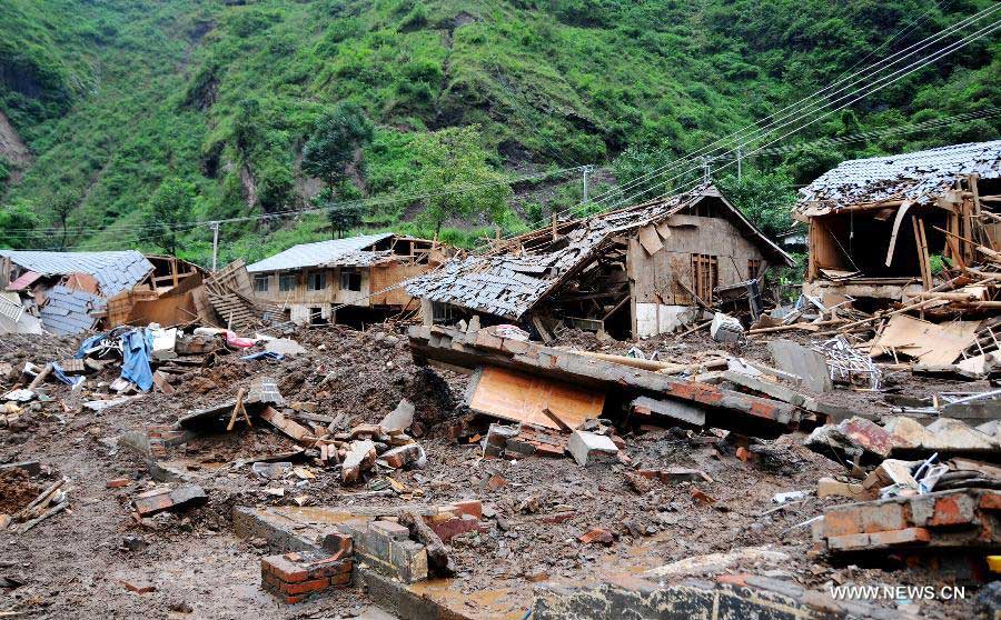 Houses are destroyed by mudslide in Hongxi Village of Pingwu County in Mianyang City, southwest China's Sichuan Province, July 12, 2013. Four people were injured and one was missing in a rain-triggered mudslide on Friday. Most of the houses in the village were buried in the mud. (Xinhua/Hu Yu)  