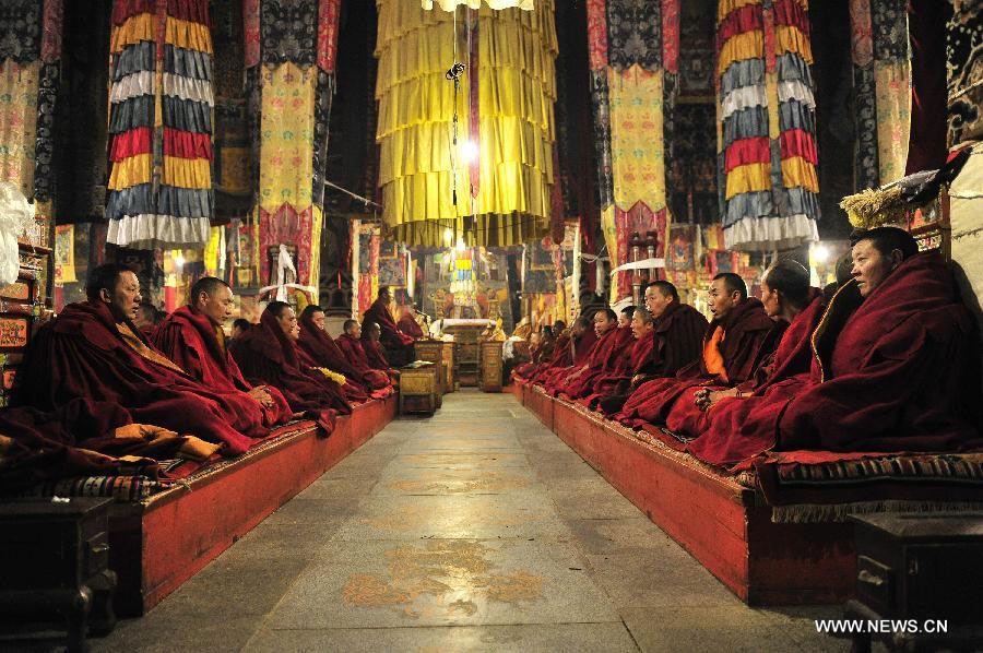Buddhists chant prayers at the Gaden Monastery in Dagze County, southwest China's Tibet Autonomous Region, July 12, 2013. The Gaden Monastery, the first monastery of the Geluk school of Tibetan Buddhism, was set up in 1409. It was listed as one of the first batch of national key cultural relics protection units in 1961. (Xinhua/Liu Kun)