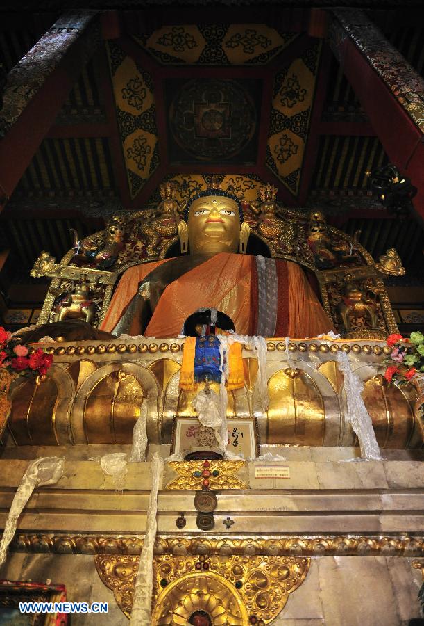 Photo taken on July 10, 2013 shows a 13-meter-high figure of Sakyamuni at the Tsurpu Monastery in Doilungdeqen County, southwest China's Tibet Autonomous Region. Founded in 1189, Tsurpu serves as the traditional seat of the Karma Kagyupa, or "White Hat Sect," of Tibetan Buddhism. (Xinhua/Liu Kun)