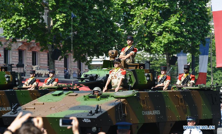 Soldiers on armoured army vehicles attend the Bastille Day military parade in Paris, France, on July 14, 2013. (Xinhua/Li Genxing) 