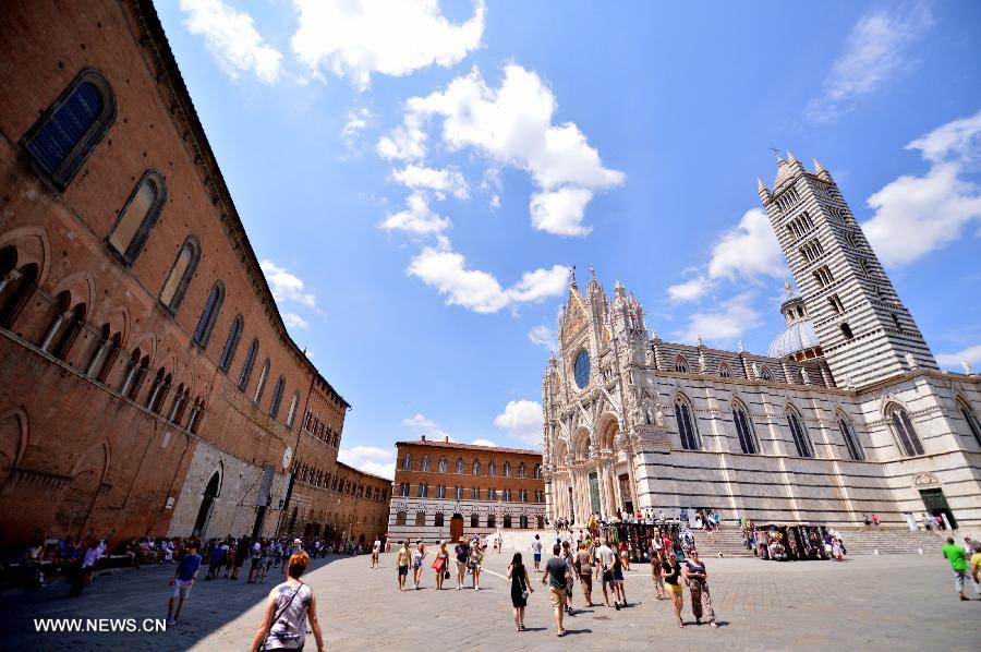 The Siena Cathedral is seen in the historic center of Siena, Tuscany of Italy, July 7, 2013. The historic center of Siena was inscribed onto UNESCO's World Heritage List in 1995. The city is famous for its medieval cityscape and the horse race Palio, attracting over 150,000 visitors every year. (Xinhua/Xu Nizhi) 