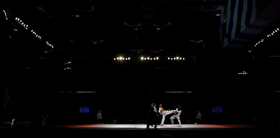 Taekwondo athletes compete in the 58 kg men's category of the Taekwondo World Championship of the World Taekwondo Federation (WTF) in the Exposition and Covention Center of Puebla, in Puebla, Mexico, on July 15, 2013. (Xinhua/Guillermo Arias) 