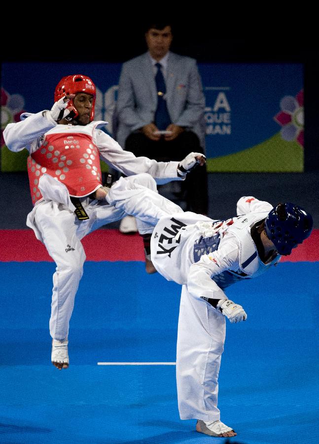 Arindo Semedo (L) from Cape Verde, blocks a kick during his combat against Damian Villa (R) from Mexico in the 58 kg men's category of the Taekwondo World Championship of the World Taekwondo Federation (WTF), in the Expositions and Coventions Center of Puebla, in Puebla, Mexico, on July 15, 2013 (Xinhua/Guillermo Arias)