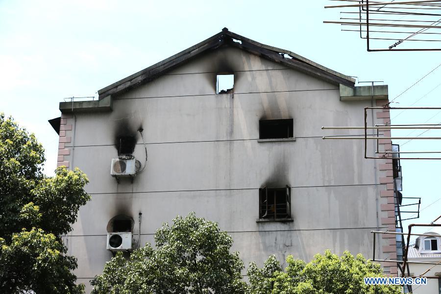 Windows are seen blackened by smoke on a residential building at Yangpu District in Shanghai, east China, July 16, 2013. A fire broke out at the five-storey building early Tuesday, leaving two people killed. Local fire department took one hour to douse the fire. (Xinhua/Yang Shichao) 