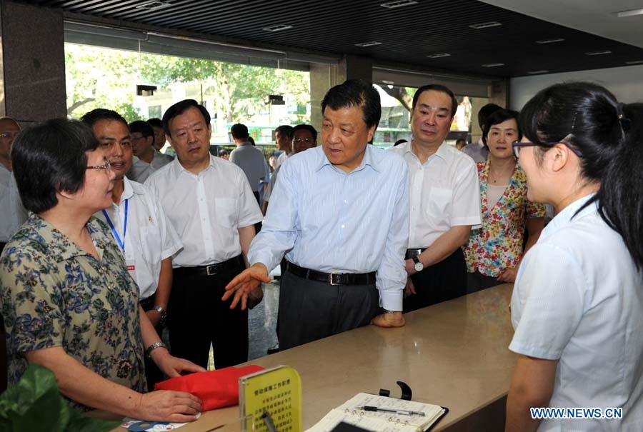 Liu Yunshan, a member of the Standing Committee of the Political Bureau of the Communist Party of China (CPC) Central Committee, visits the Cuiyuan Community in Xihu District of Hangzhou, capital of east China's Zhejiang Province, July 12, 2013. China's top leadership has called on local officials to vigorously promote the "mass line" education campaign and apply it to boosting development and people's livelihoods. "Mass line" refers to a guideline under which CPC officials and members are required to prioritize the interests of the people and persist in representing them and working on their behalf. (Xinhua/Rao Aimin)