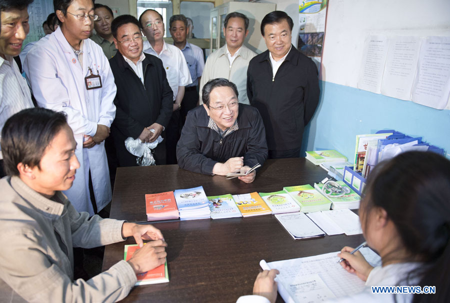 Yu Zhengsheng, a member of the Standing Committee of the Political Bureau of the Communist Party of China (CPC) Central Committee, visits a township hospital in Gannan Tibetan Autonomous Prefecture, northwest China's Gansu Province, July 7, 2013. China's top leadership has called on local officials to vigorously promote the "mass line" education campaign and apply it to boosting development and people's livelihoods. "Mass line" refers to a guideline under which CPC officials and members are required to prioritize the interests of the people and persist in representing them and working on their behalf. (Xinhua/Li Xueren)