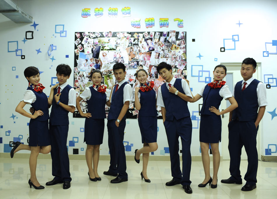 Students of flight attendant major in Inner Mongolia Normal University pose for photo on July 8, 2013. (Xinhua/Jin Yu)