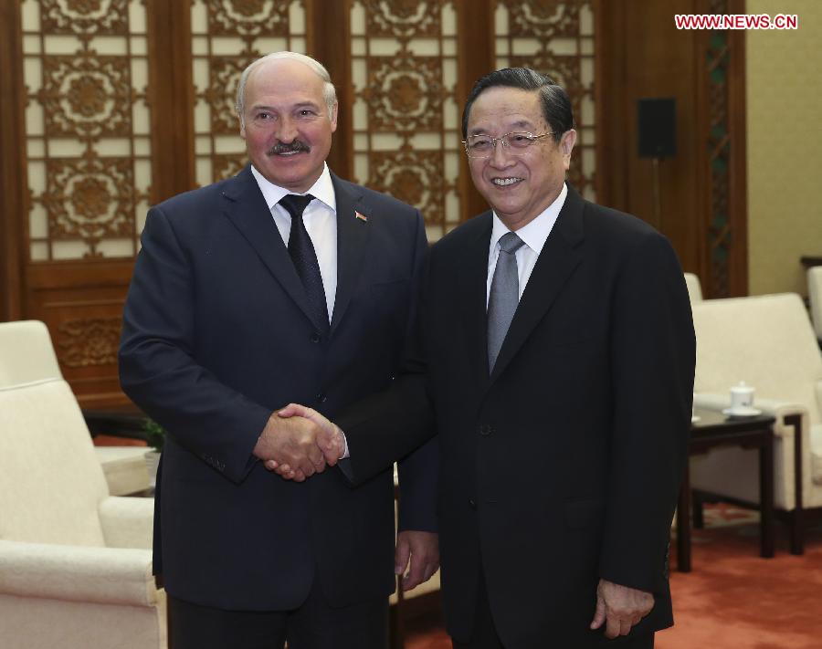 Yu Zhengsheng (R), chairman of the National Committee of the Chinese People's Political Consultative Conference (CPPCC), shakes hands with Belarusian President Alexander Lukashenko during their meeting at the Great Hall of the People in Beijing, capital of China, July 17, 2013. (Xinhua/Pang Xinglei)