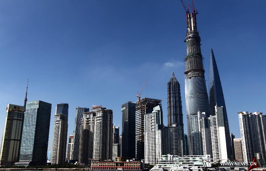 Photo taken on July 17, 2013 shows Shanghai Tower under construction in east China's Shanghai. Shanghai Tower is soon to seal its roof and will redefine the Lujiazui area skyline. Shanghai Tower will be the tallest building in China, and the second-tallest in the world.(Xinhua/Pei Xin)