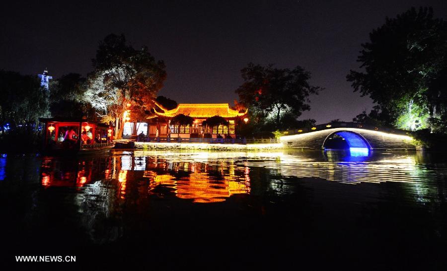 Photo taken on July 17, 2013 shows the night view of the Slender West Lake in Yangzhou, east China's Jiangsu Province. The night tour for visiting the Slender West Lake opened here on Wednesday. (Xinhua/Meng Delong) 