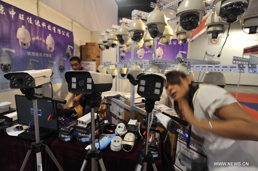 A staff member tests monitoring system at the 2013 China International Exhibition on Public Safety and Security in Beijing, capital of China, July 18, 2013. The exhibition kicked off on Thursday at China International Exhibition Center. (Xinhua/Wang Jingsheng) 