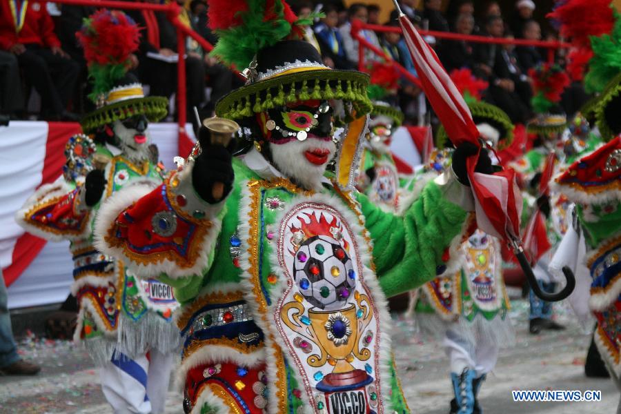 Youth participate in a school parade performing folk dances of Peru, in the Armas Square of the city of Peru, capital of Peru, on July 20, 2013. The "Third School Parade", which is called Millennial and Cultural Lima and organized by the city of Lima, brings together all the schools in the city to commemorate the upcoming national holiday on July 28. (Xinhua/Luis Camacho) 