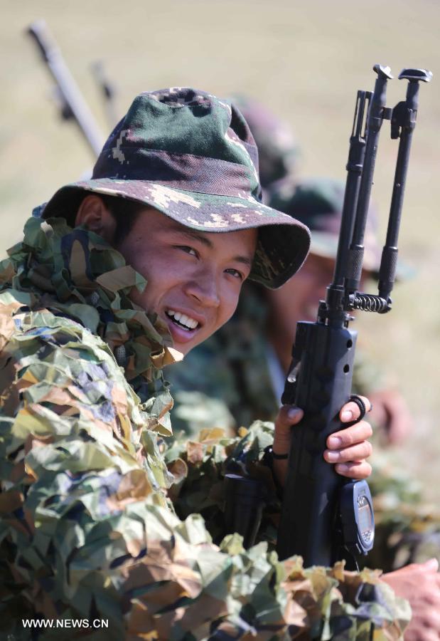 A member of China's People's Liberation Army (PLA) special forces reacts during a comprehensive military contest at a PLA training base in north China's Inner Mongolia Autonomous Region, July 23, 2013. (Xinhua/Wang Jianmin)