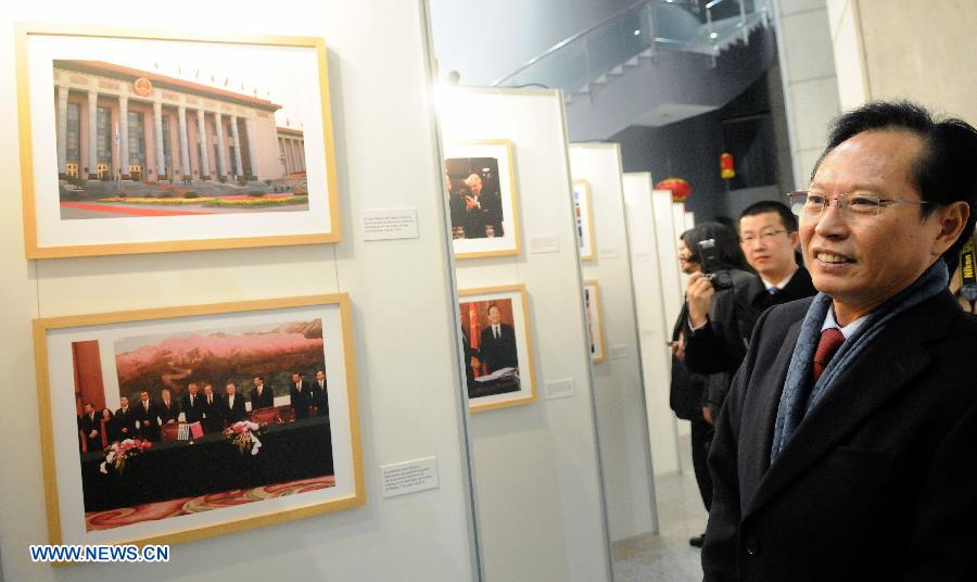 Chinese Ambassador to Uruguay Yan Banghua (R) views photos in the "25 Years of Diplomatic Relations between Uruguay and China" exhibition in Montevideo, capital of Uruguay, on July 23, 2013. The photo exhibition was organized by Uruguay's Presidency, the Foreign Ministry and the Chinese Embassy to Uruguay. (Xinhua/Nicolas Celaya)