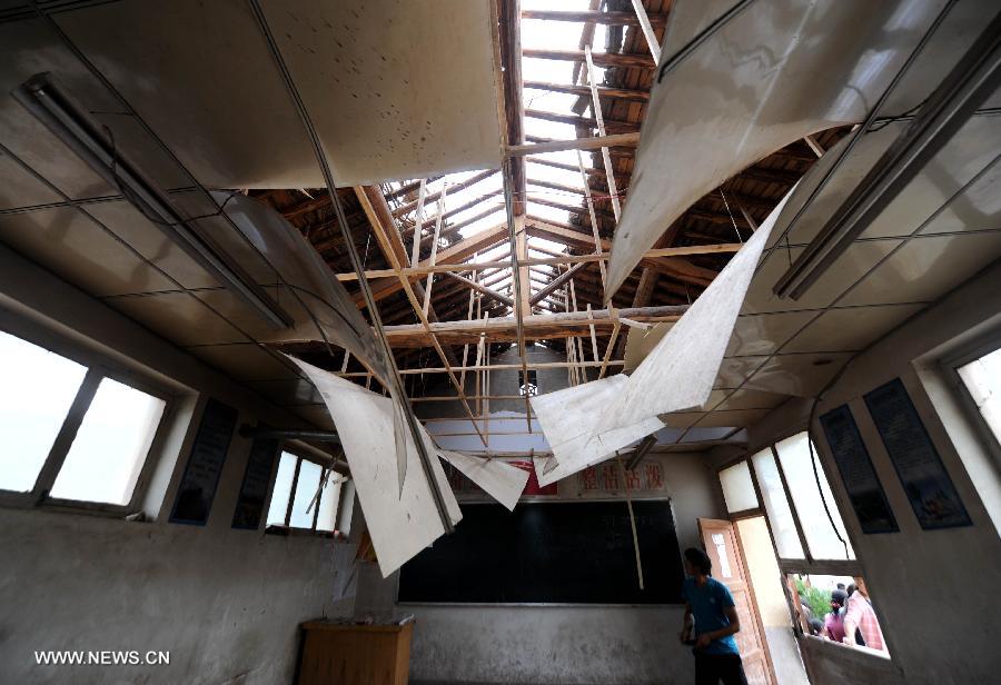 Photo taken on July 24, 2013 shows a damaged classroom of a primary school in the quake-hit Majiagou Village in Meichuan Township, Minxian County, northwest China's Gansu Province. Over 360 schools in Gansu's Minxian and Zhangxian counties were destroyed by the 6.6-magnitude quake that occurred on Monday, affecting 77,000 students, according to the local authorities. (Xinhua/Luo Xiaoguang)