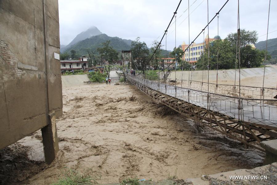 Floodwater is seen in a river in Huangzhu Town of Chengxian County, northwest China's Gansu Province, July 25, 2013. A torrential rain battered Chengxian County from Wednesday night to Thursday morning, causing landslide and traffic disruption. (Xinhua/Wu Tingdong)