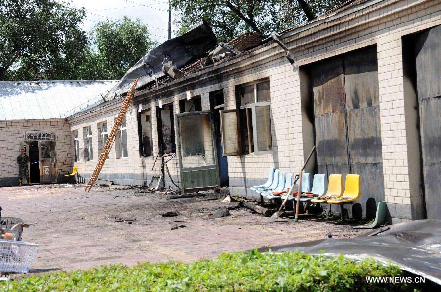 Photo taken on July 26, 2013 shows the accident site at the Lianhe Senior Nursing Home where a fire took place in Hailun City, northeast China's Heilongjiang Province. Eleven people were killed in the fire that occurred early Friday. Local police said arson has been confirmed as the cause of the fire. A total of 283 elderly people were living in the nursing home, which was built in October 2005. With an area of 7,000 square meters, it caters for the rural elderly in the city who have no source of income. (Xinhua/Wang Song)