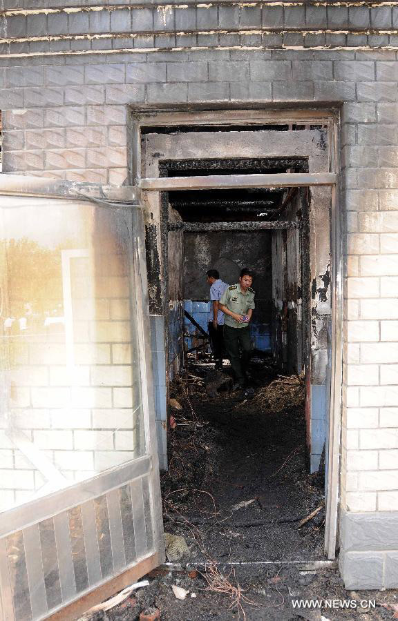 Photo taken on July 26, 2013 shows the accident site at the Lianhe Senior Nursing Home where a fire took place in Hailun City, northeast China's Heilongjiang Province. Eleven people were killed in the fire that occurred early Friday. Local police said arson has been confirmed as the cause of the fire. A total of 283 elderly people were living in the nursing home, which was built in October 2005. With an area of 7,000 square meters, it caters for the rural elderly in the city who have no source of income. (Xinhua/Wang Song)