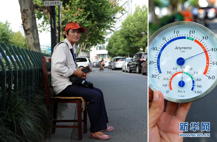 Xu Ping stays on duty on July 23; she is a fee charger who works at an outside car parking in Hangzhou. Thermometer displays the temperature is 40 degree Celsius at that time. (Xinhua/ Ju Huanzong )