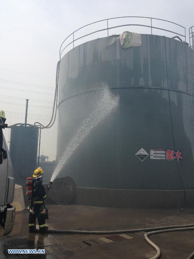 A fireman sprays water over a leaking ammonia storage tank at a chemical plant in Taixing City, east China's Jiangsu Province, July 26, 2013. A leakage was found at the 300-ton tank of Yichu Chemical Co., Ltd. at 7 a.m. Friday, leaving several people poisoned. Rescuers have taken emergency measures to stop the leak. (Xinhua/Yang Hai)