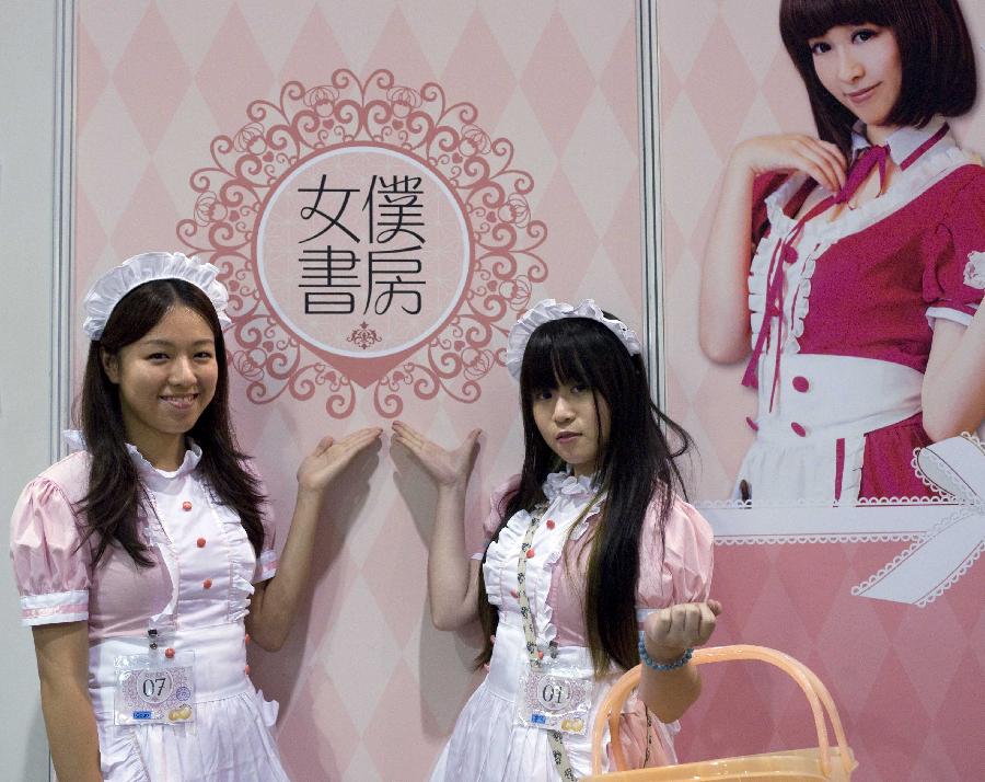 Staff members in maidservant dress pose at the Animation, Comics & Games Expo in Hong Kong (ACGHK), south China, July 26, 2013. The five-day ACGHK, starting here Friday, is expected to attract some 700,000 visitors. (Xinhua/Zhao Yusi) 