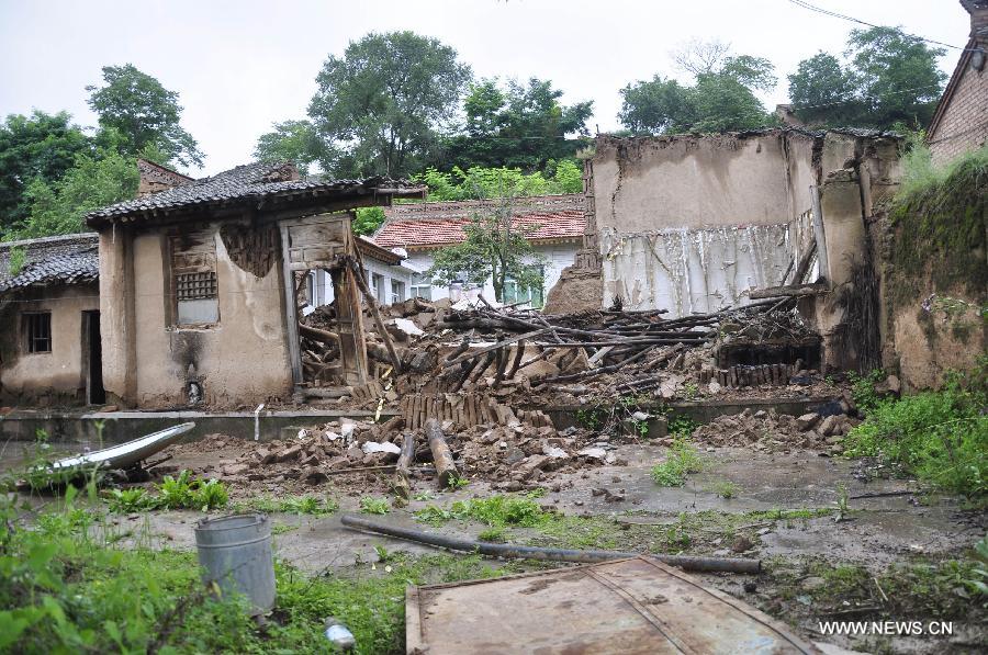 A house is seen damaged in rainstorm-hit Zhangjiachuan Hui Autonomous County in northwest China's Gansu Province, July 28, 2013. (Xinhua/Dou Miaomiao)