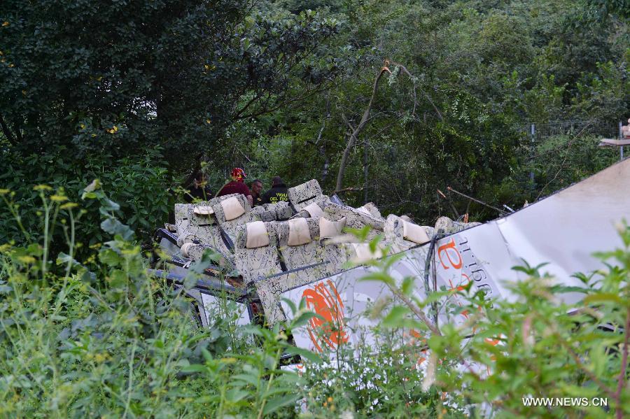 Photo taken on July 29, 2013 shows the wrecked tourist bus in Avellino, southern Italy. A tourist bus crashed through a highway guardrail in southern Italy Sunday night, killing 38 people and putting at least 10 others in critical condition. (Xinhua/Xu Nizhi) 