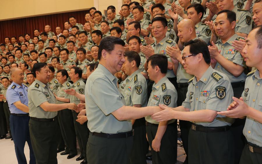 Chinese President Xi Jinping (C), also general secretary of the Central Committee of the Communist Party of China (CPC) and chairman of the Central Military Commission (CMC), shakes hands with military cadre during his tour of the Beijing Military Area Command in Beijing, capital of China, July 29, 2013. Xi made this visit ahead of the Army Day, which falls on Aug. 1 and marks the 86th anniversary of the founding of the People's Liberation Army (PLA). (Xinhua/Li Gang)